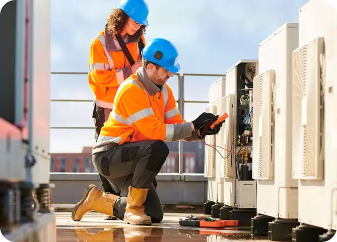 A man and woman technicians doing measurements and maintenance of rooftop equipments.